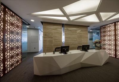 Sophisticated reception area with a geometric white desk and patterned screens.