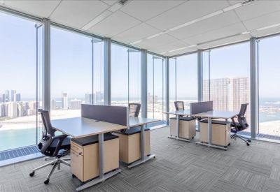 Long boardroom table with black chairs under a modern illuminated ceiling feature.