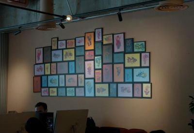 Wall art featuring a colorful grid of images.