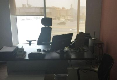 Private office at 8166 King Abdul Aziz Road with a large window overlooking the city.