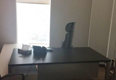 Private office suite featuring a dark wood desk and ergonomic chair.