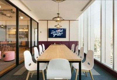 Professional meeting room with a long wooden table, white chairs, and city views.