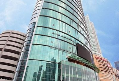 Exterior view of the glass-facade AXA Tower rising above the city skyline.