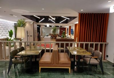 Cafe-style seating area with leather booths and modern overhead lighting.