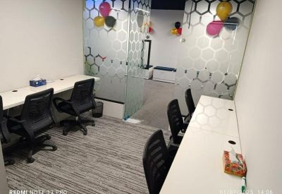 Private four-person office suite featuring glass walls decorated with balloons.