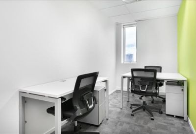 Spacious boardroom featuring a wood-panelled feature wall, wall-mounted screen, and grey executive chairs.