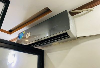 Wall-mounted split air conditioning unit in a modern office space.