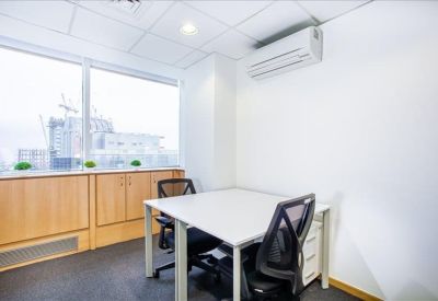 Private two-person office with large window and natural light.