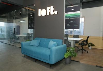 Reception and lounge at Bhamti, Subhash Nagar, Trimurti Nagar with a blue sofa and branded loft sign.