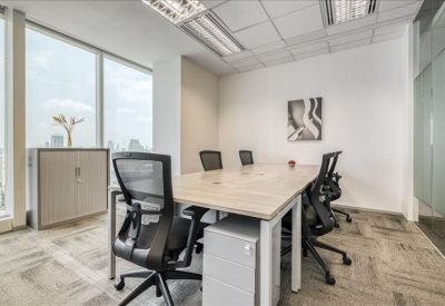 Bright conference room featuring a light wood table, black mesh chairs, and large windows with a city view.
