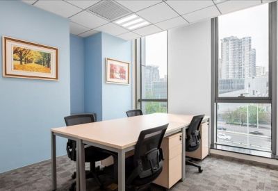 Bright corner office with blue feature walls and large windows overlooking the city.