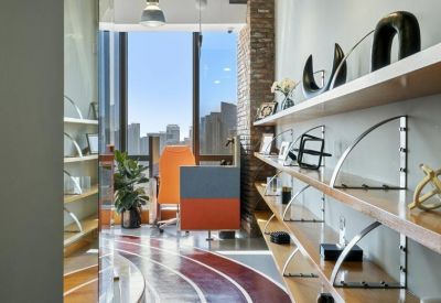 Corridor featuring built-in shelving and a view into a bright office area.