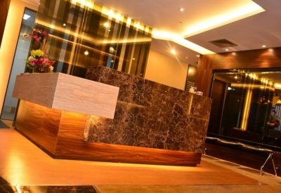 Polished reception desk with marble finishes and warm accent lighting.