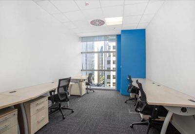 Bright private office suite with large windows and a blue accent wall.