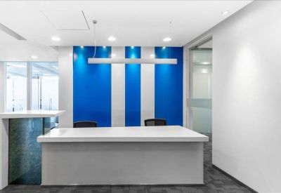 Minimalist reception desk backed by a blue and white striped feature wall.