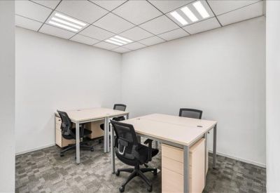 Small internal office suite with two desks and black ergonomic chairs.