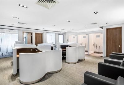 Common area with curved white reception pods and dark leather seating.