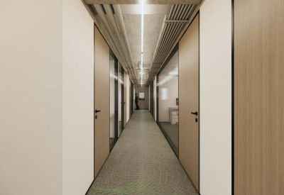 Bright office corridor with wood-paneled doors and linear ceiling lighting.