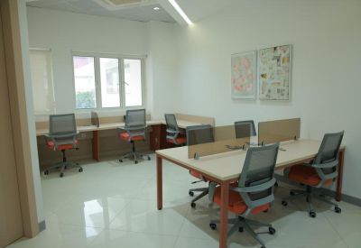 Bright office with multiple workstations and abstract wall art.