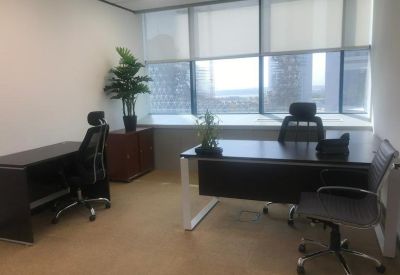 Private office suite with executive desks and large windows offering city views.