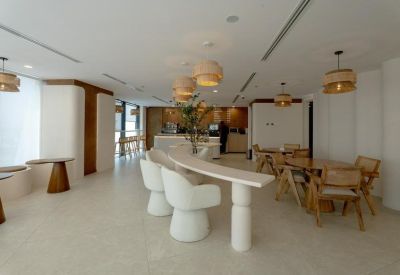 Café-style space with tables and chairs under pendant lighting.