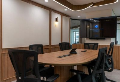 Conference room with wood paneling and a large central table.