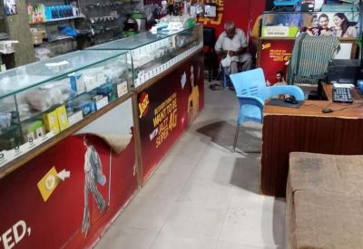 Interior retail space with mobile accessory displays and a seating area for customers.