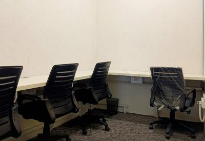 Small four-person office suite with a long white desk and overhead air conditioning.