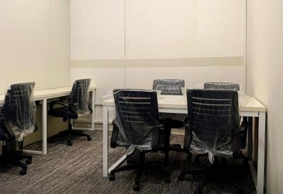 Private office setup for eight people with minimalist desks and bright lighting.