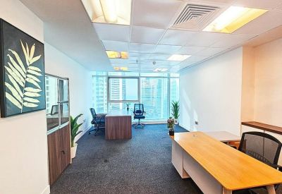 Spacious private office with wooden desks and palm leaf wall art.