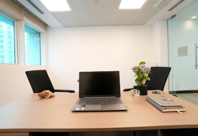 Minimalistic office with a laptop at the forefront.