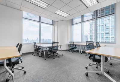 Bright corner office with multiple workstations and expansive city views.