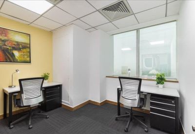 Private two-person office with grey chairs and a framed artwork.