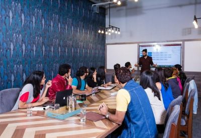 Large meeting room featuring a long wooden table and blue patterned feature wall.