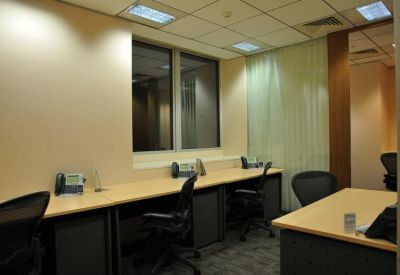 Private office space with multiple workstations and desktop telephones.