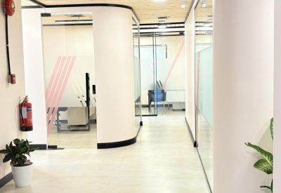 Wide corridor with curved white walls and minimalist decor.