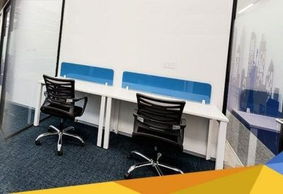 Workspace with two desks and blue privacy screens.