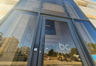 Glass entrance door with corporate logo and electronic keypad access.