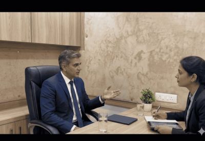 Executive office suite with wood-paneled walls and two professionals in a business meeting.