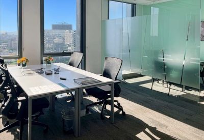 Bright communal area with seating and high windows.