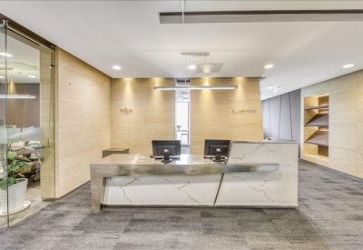 Reception area with a marble desk and computers.