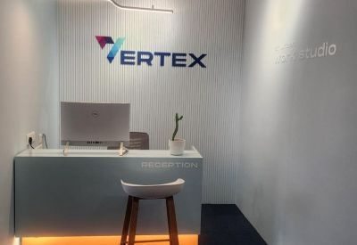 Modern reception desk with branded Vertex signage and warm under-counter lighting at J S Towers.