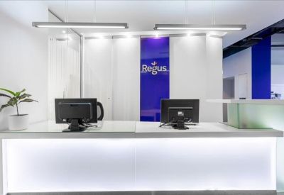 Sleek white reception desk with blue branding and modern pendant lighting.