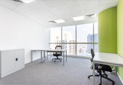 Bright two-person office with a green feature wall and large city-view window.
