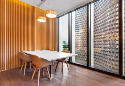 Modern dining area with wooden wall paneling and city views through large windows.
