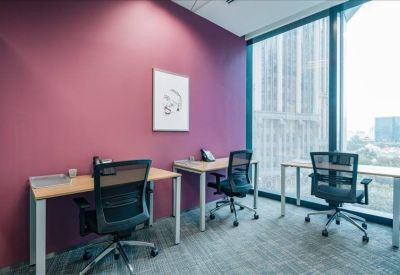 Internal office space with three desks and a purple feature wall.