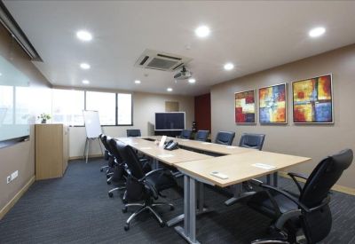 Spacious boardroom featuring a long wooden table and modern artwork.