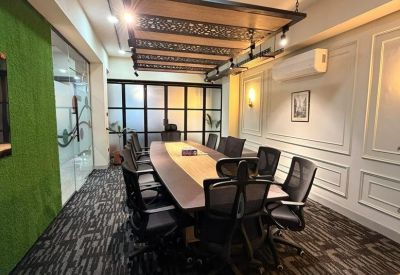 Sleek boardroom with an industrial-style chandelier and ergonomic chairs.