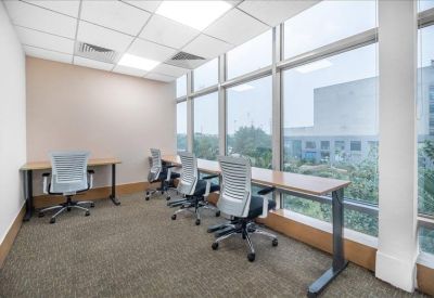 Private office suite with desks and large windows overlooking the city.