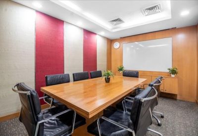 Professional boardroom featuring a long wooden table and red-and-white paneled walls.